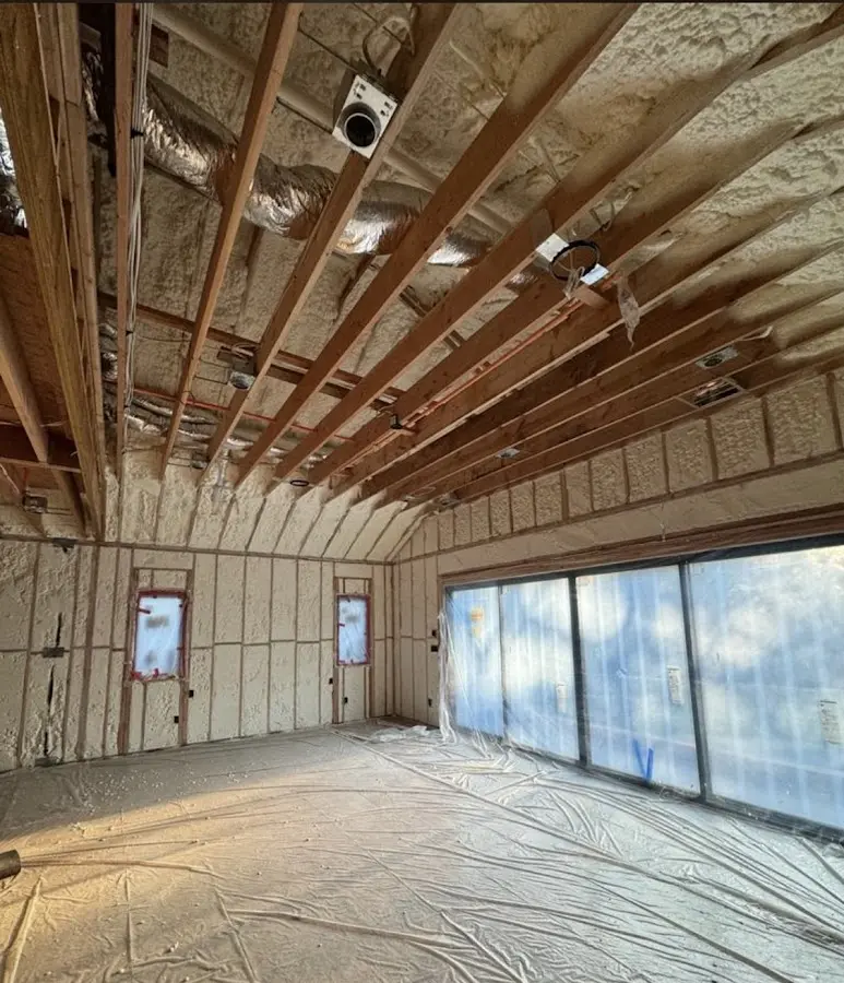 Interior walls and ceiling insulated with spray foam during new construction in Randolph